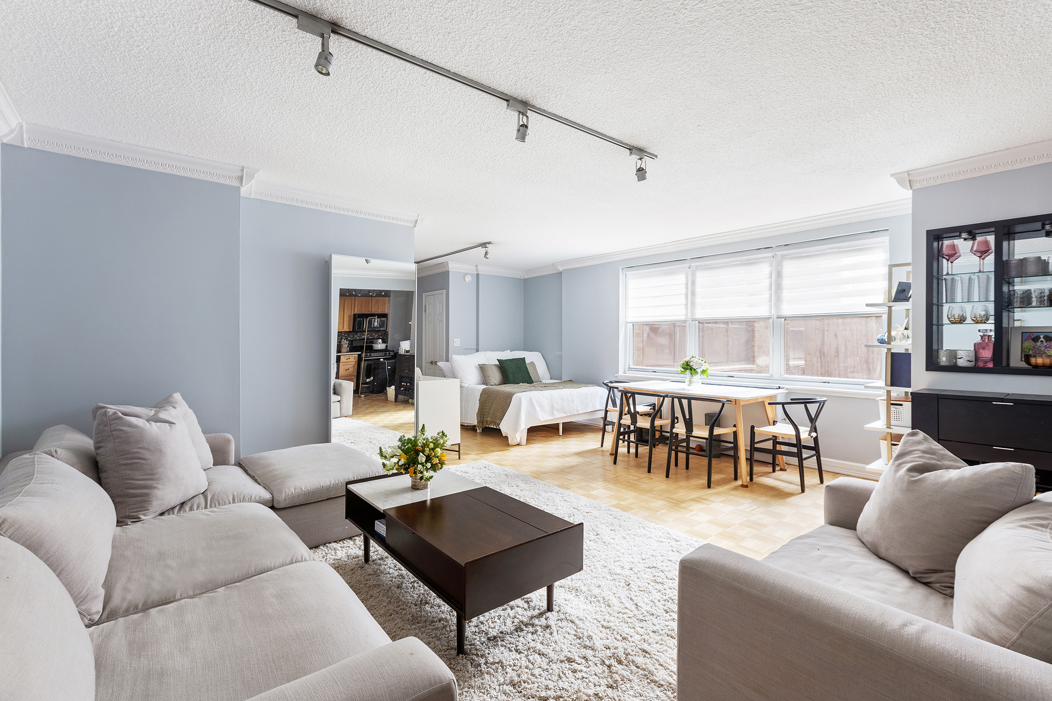 200 East 24th Street, Unit 201 Manhattan, NY 10010 - Photo 2 of 7 a living room with furniture kitchen view and a large window