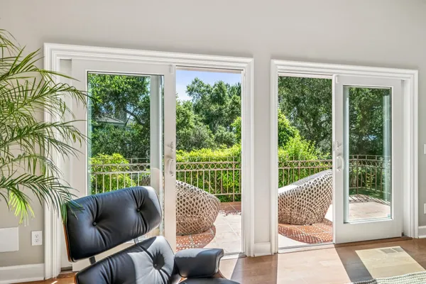 a balcony with furniture and garden view