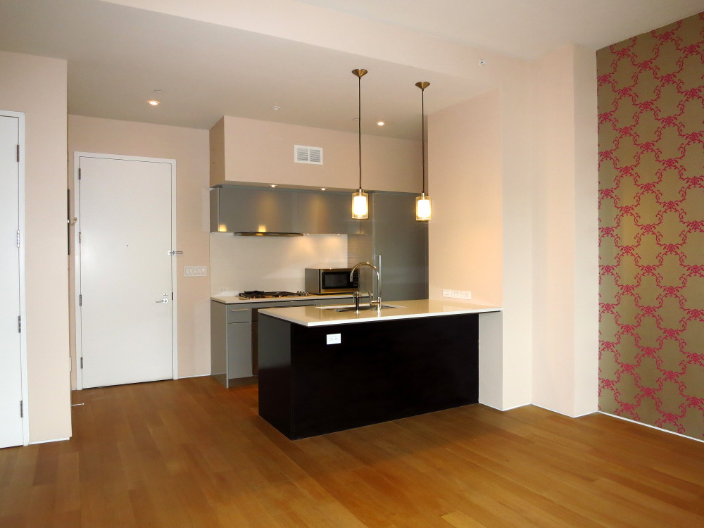 123 3rd Avenue, Unit 12B Manhattan, NY 10003 - Photo 3 of 6 a kitchen with stainless steel appliances granite countertop a sink a stove and a refrigerator