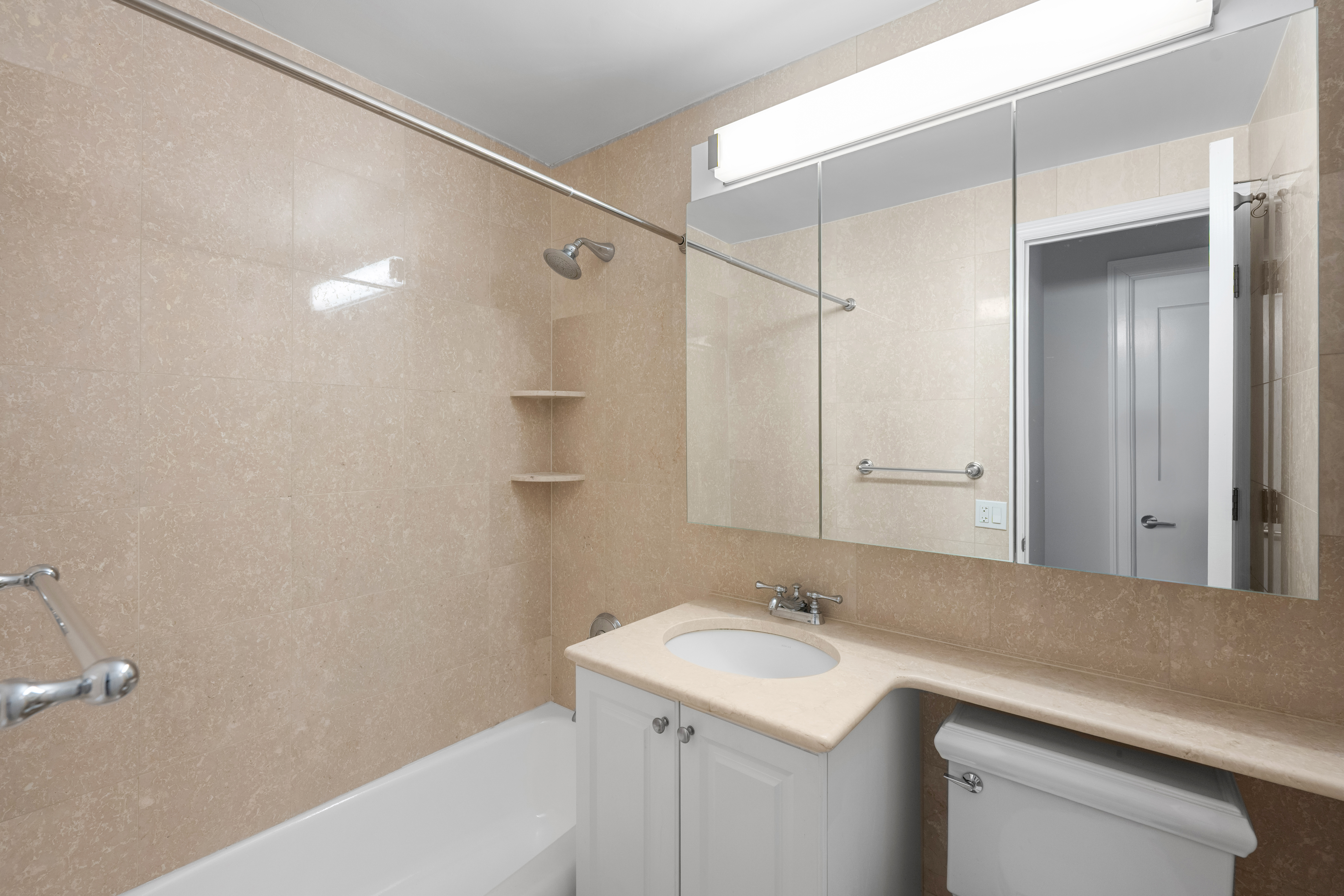 155 West 68th Street, Unit 815 Manhattan, NY 10023 - Photo 10 of 14 a bathroom with a sink and a mirror