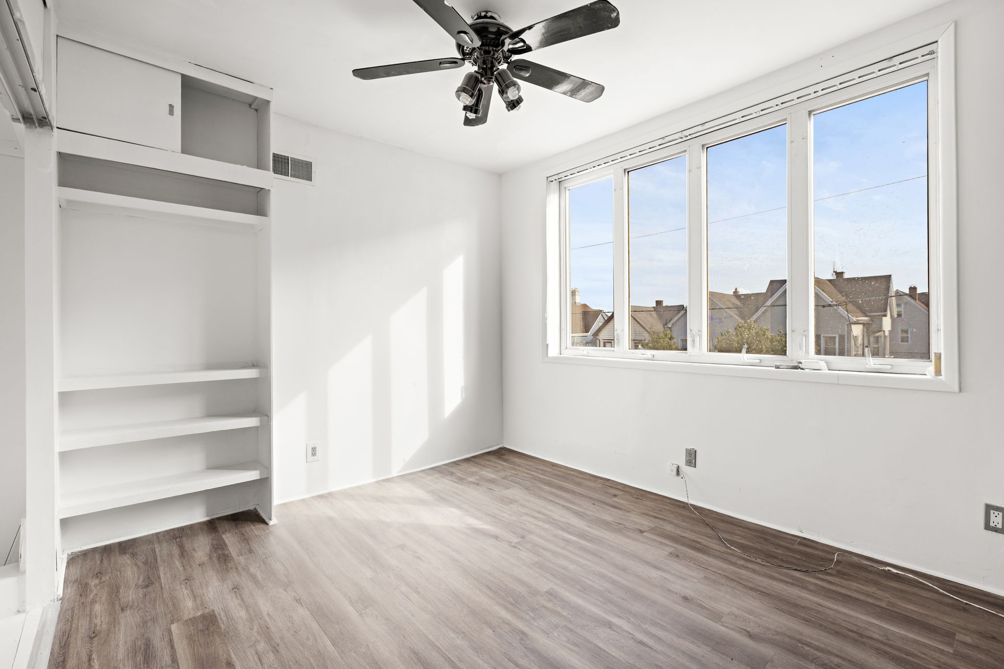 West 43rd Street Bayonne, NJ 07002 - Photo 13 of 22 a view of an empty room with a window and wooden floor