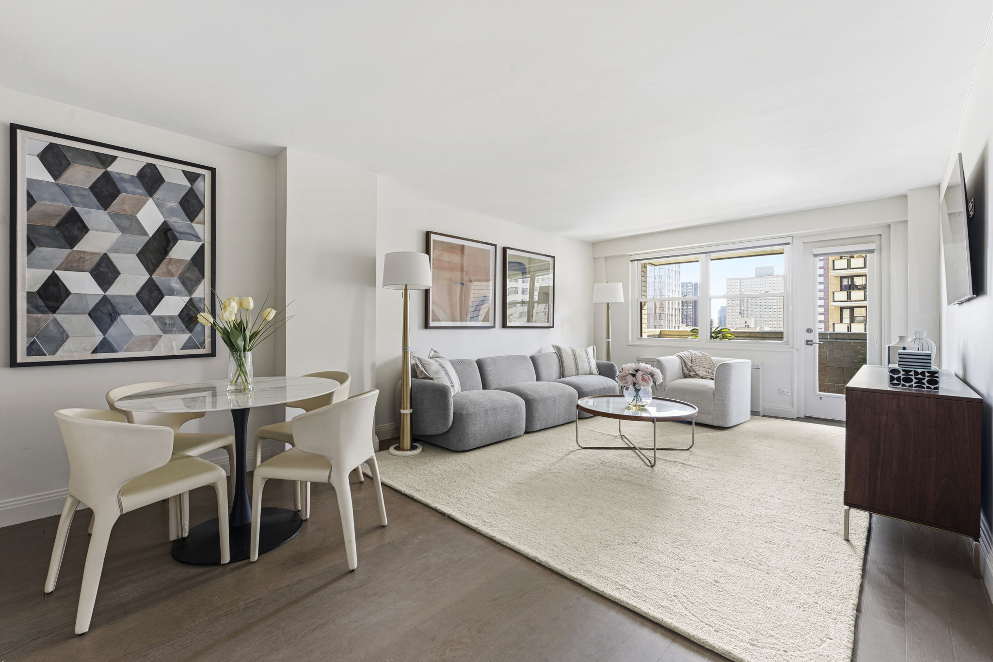 245 East 87th Street, Unit 17C Manhattan, NY 10128 - Photo 3 of 11 a living room with furniture and a large window