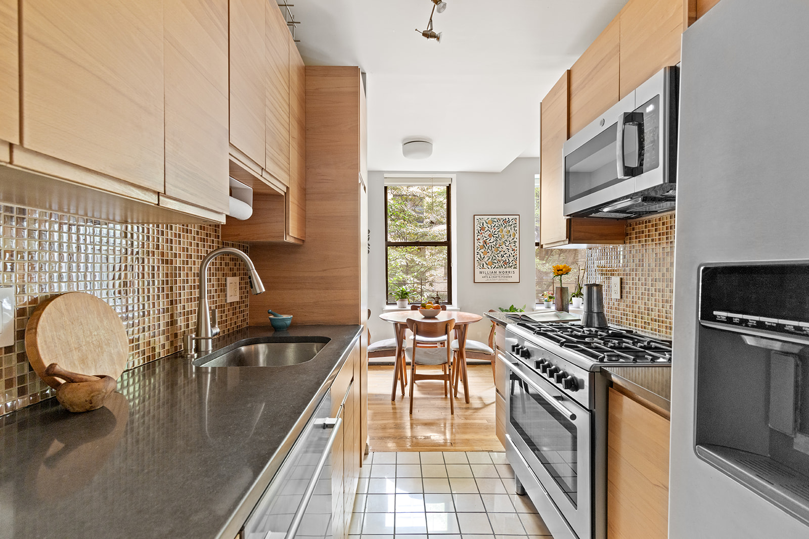 295 St Johns Place, Unit 1C Brooklyn, NY 11238 - Photo 7 of 17 a kitchen with stainless steel appliances a stove a sink a refrigerator cabinets and furniture