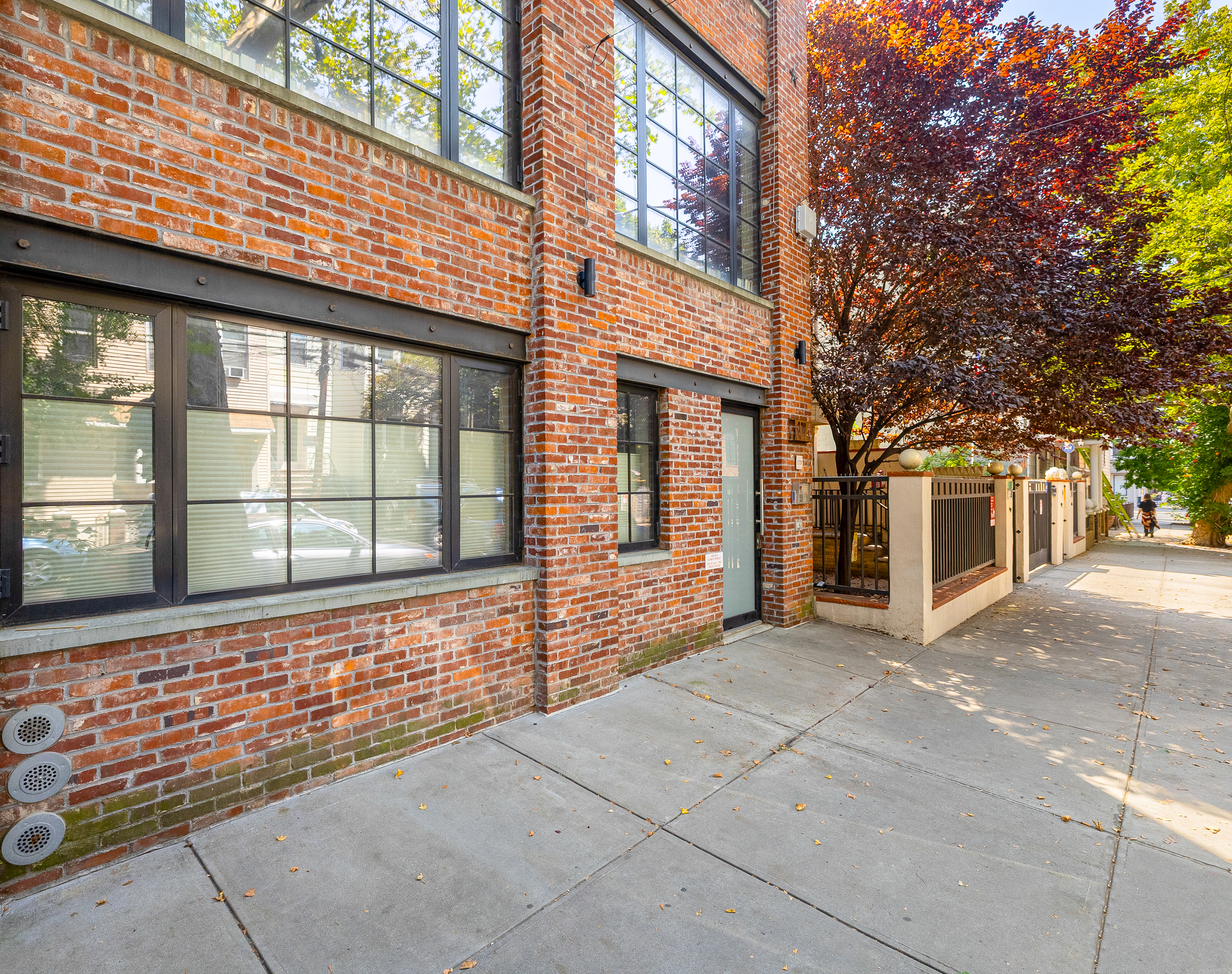174 Jackson Street, Unit 2A Brooklyn, NY 11211 - Photo 14 of 17 a front view of a brick house with large windows