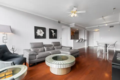 a bedroom with a bed a couch and a large window