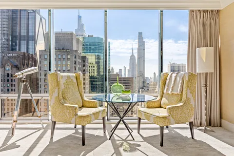 a view of a balcony with table and chairs