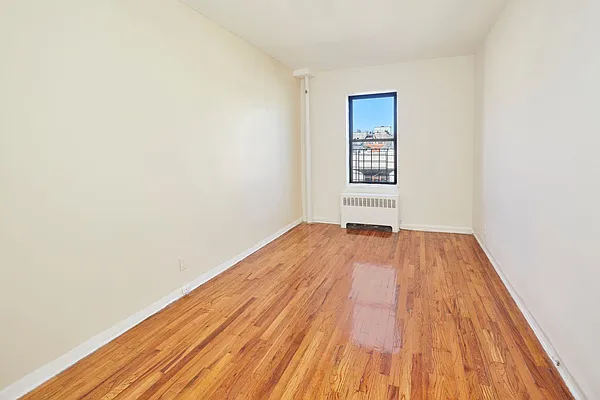506 West 145th Street, Unit 4D Manhattan, NY 10031 - Photo 3 of 9 a view of a room with wooden floor and white walls