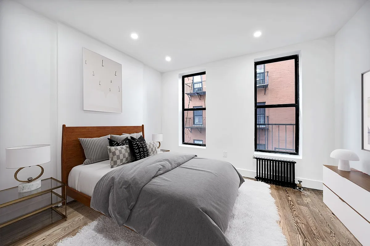 66 West 138th Street, Unit 1A Manhattan, NY 10037 - Photo 4 of 6 a bedroom with a large bed and a window