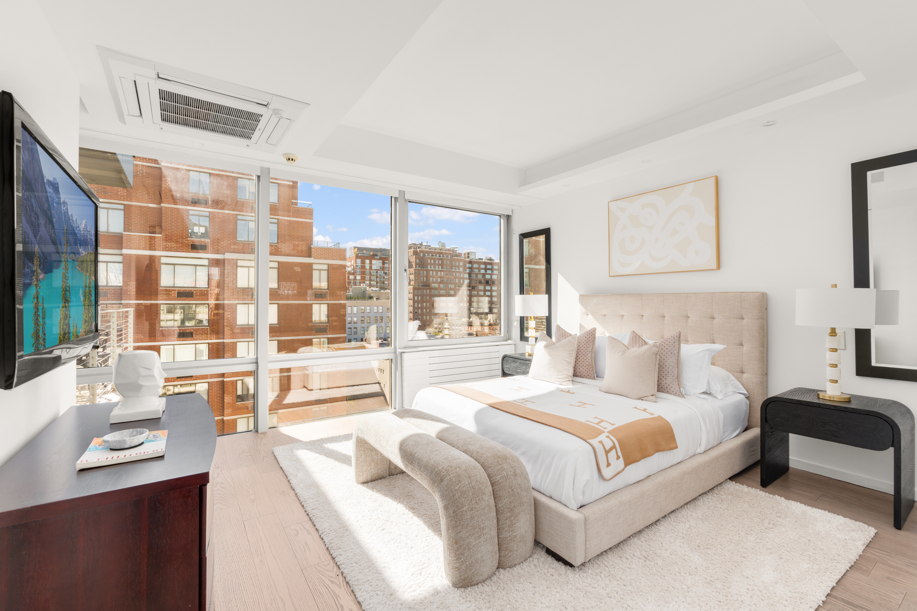 245 West 19th Street, Unit PH4 Manhattan, NY 10011 - Photo 5 of 10 a spacious bedroom with a large bed and a large window