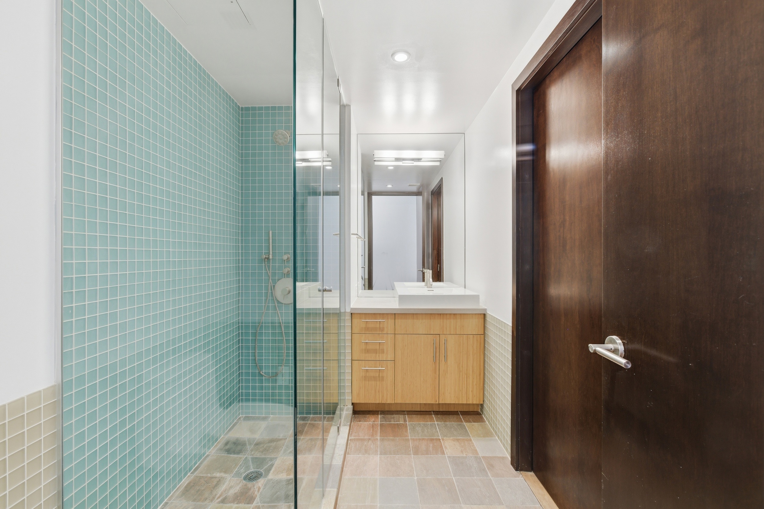 135 West 4th Street, Unit 3W Manhattan, NY 10012 - Photo 21 of 24 a bathroom with a glass shower door a sink and a mirror