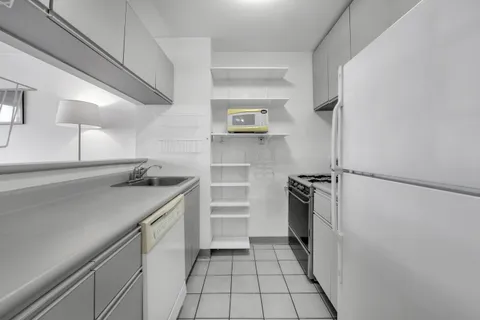 a kitchen with a refrigerator and a sink