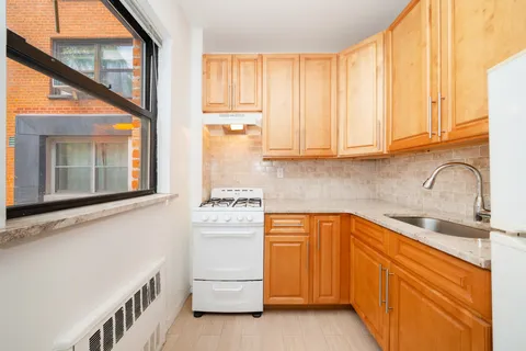 a kitchen with white cabinets and a sink