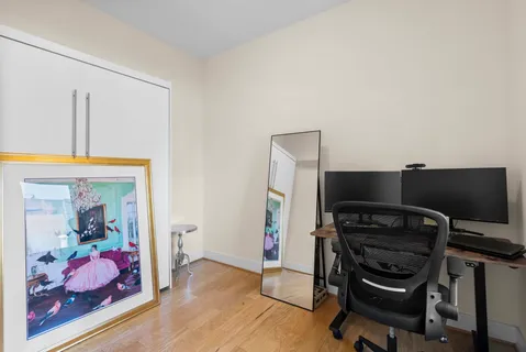 a view of a workspace with furniture and wooden floor