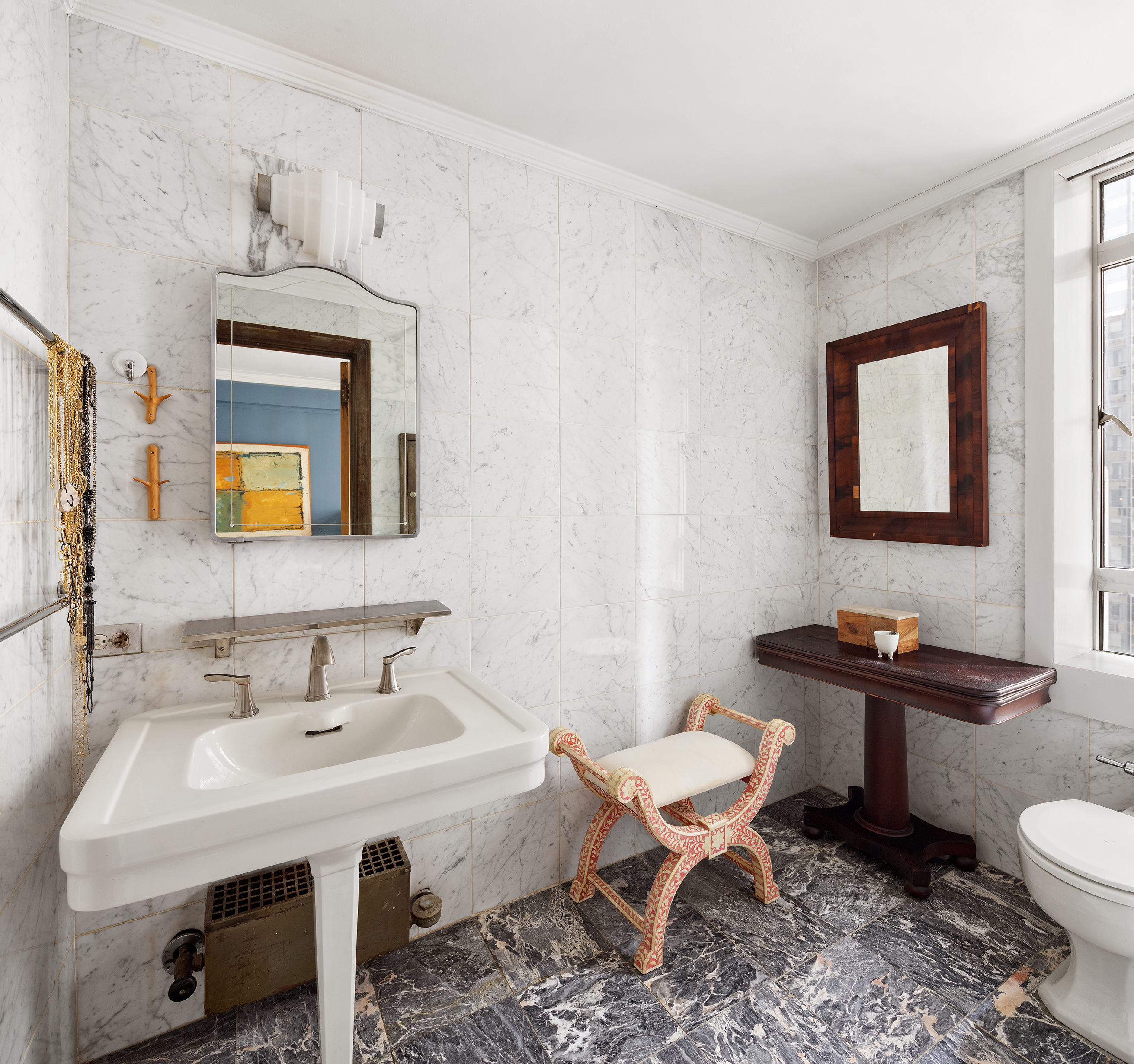 25 Central Park West, Unit 11C Manhattan, NY 10023 - Photo 8 of 17 a bathroom with a sink a toilet and mirror