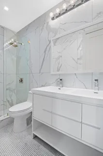 a bathroom with a sink toilet and shower