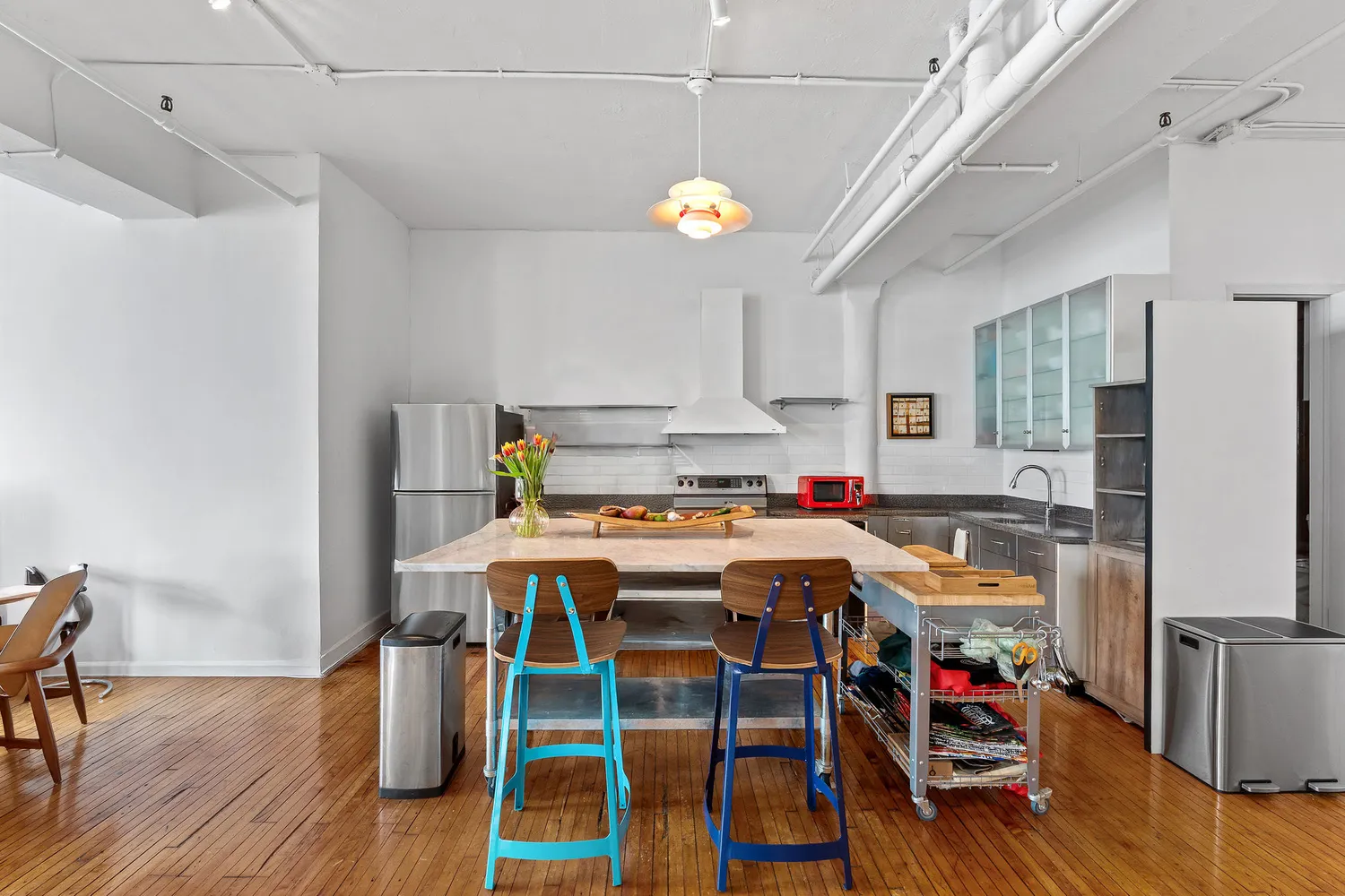a kitchen with stainless steel appliances granite countertop a sink stove and cabinets