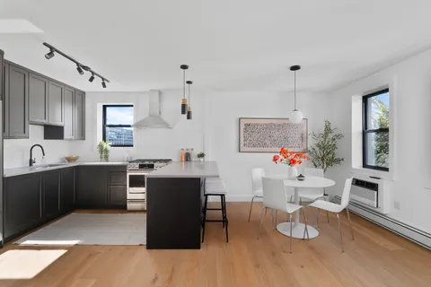 a living room with furniture and kitchen view
