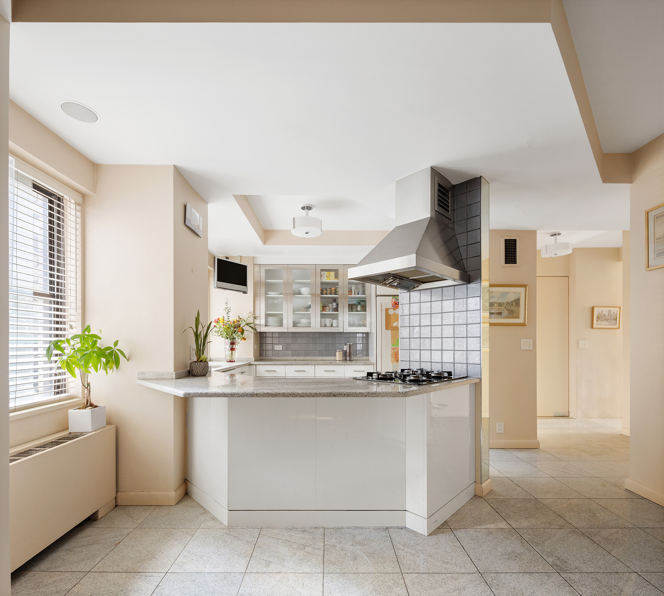 785 5th Avenue, Unit 5C Manhattan, NY 10022 - Photo 8 of 14 a kitchen with stainless steel appliances granite countertop a sink and a stove