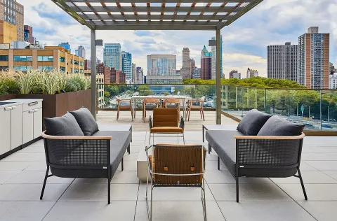 a backyard of a house with table and chairs