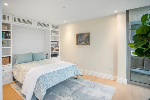 a bedroom with a bed and a potted plant