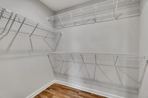 an empty room with a window and a ceiling fan