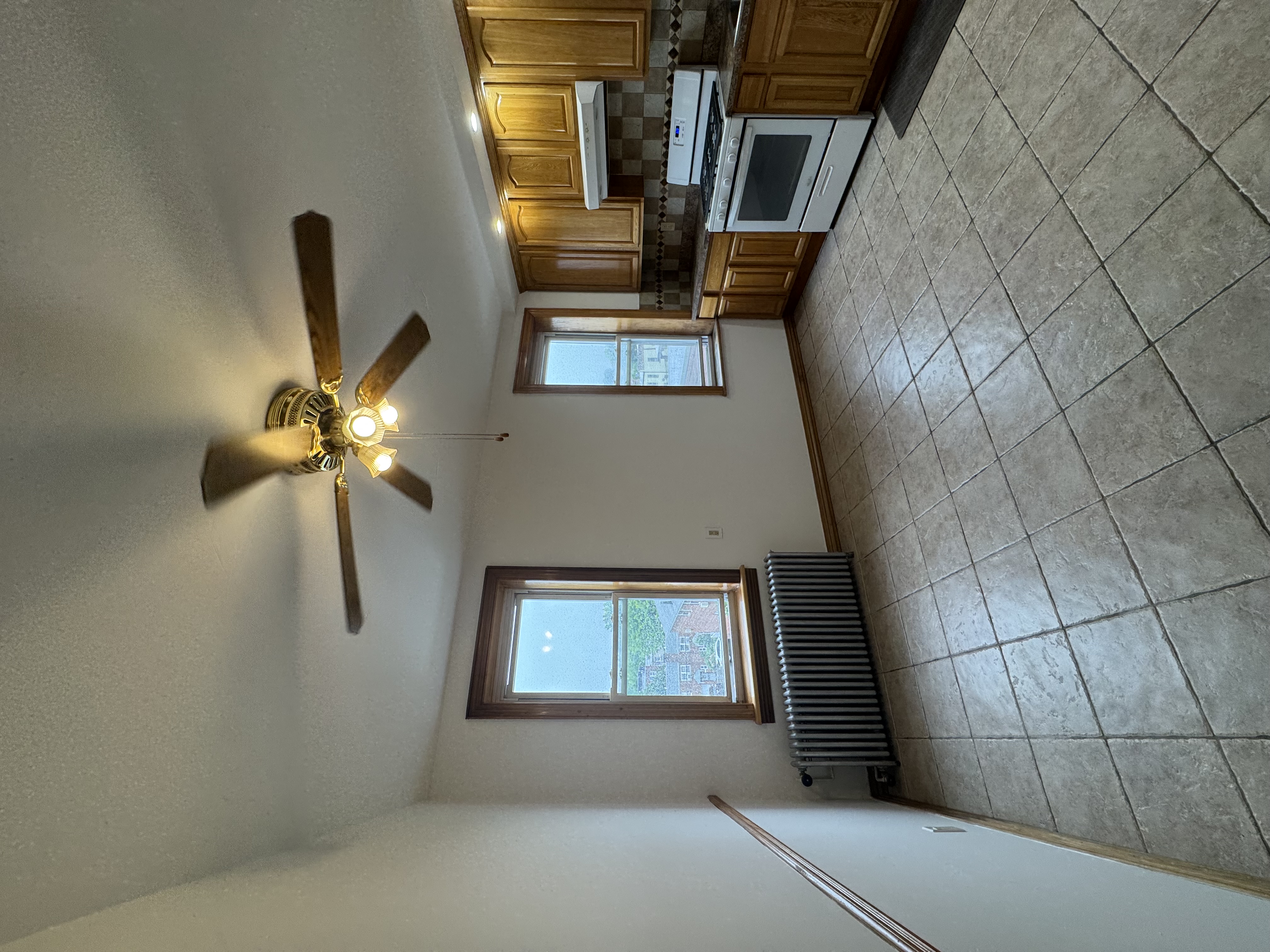 60-27 56th Road, Unit 3 Queens, NY 11378 - Photo 1 of 9 a view of an empty room with a kitchen