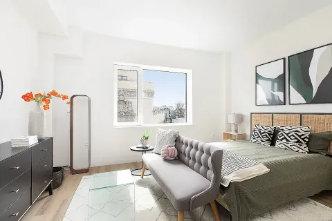 a bedroom with a bed dresser and a window