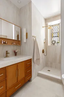 a bathroom with a tub sink a mirror and a shower