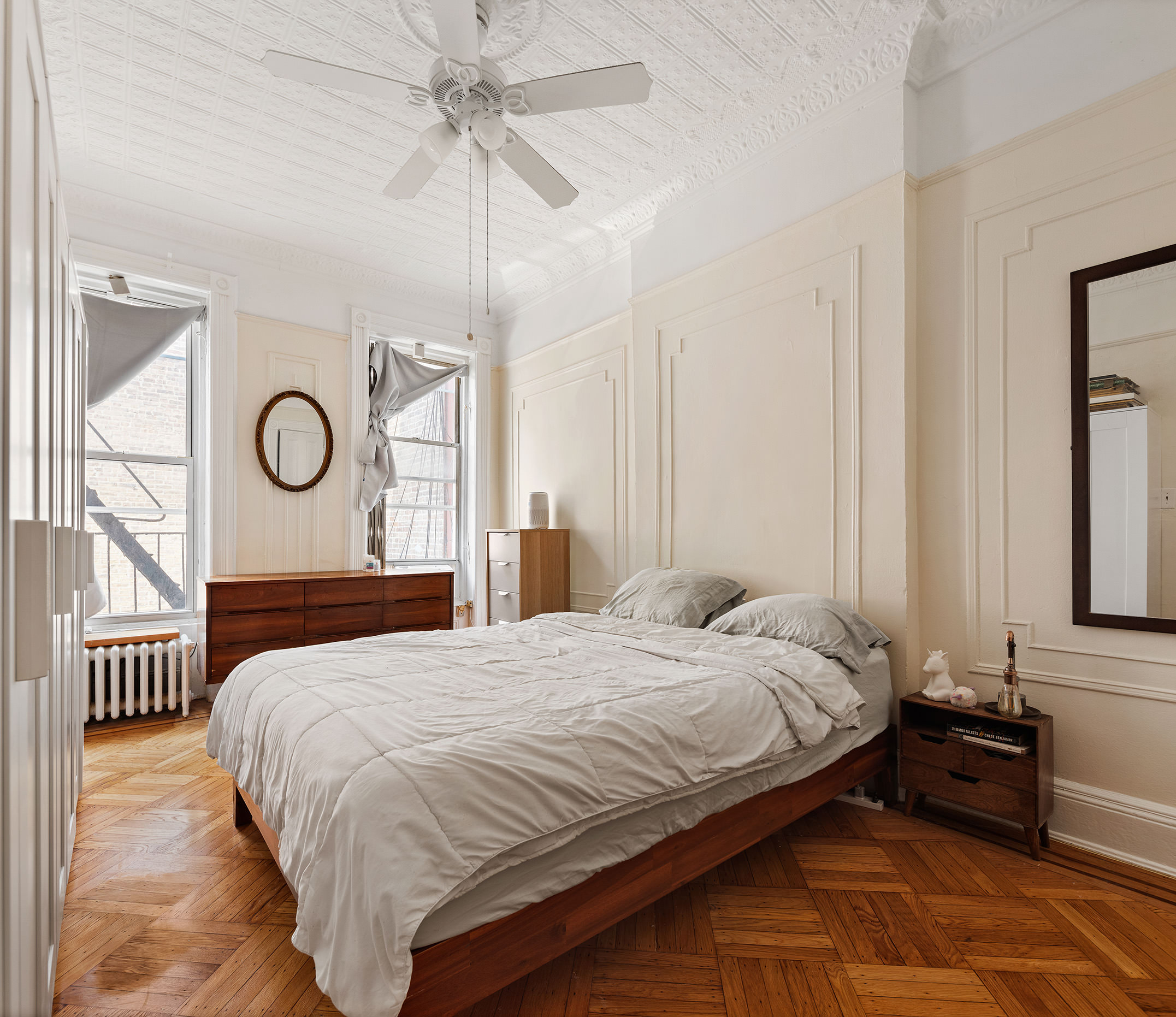 80 7th Avenue Brooklyn, NY 11217 - Photo 4 of 8 a bedroom with a bed and a chandelier