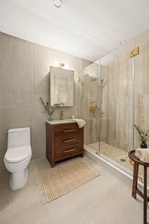 a bathroom with a sink a toilet and shower