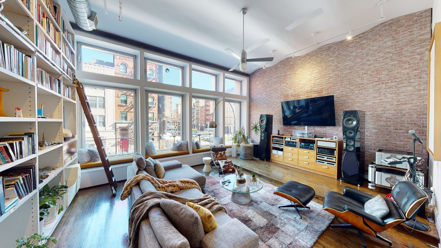 382 Lafayette Street, Unit 2 Manhattan, NY 10003 - Photo 1 of 19 a living room with furniture a flat screen tv and a floor to ceiling window