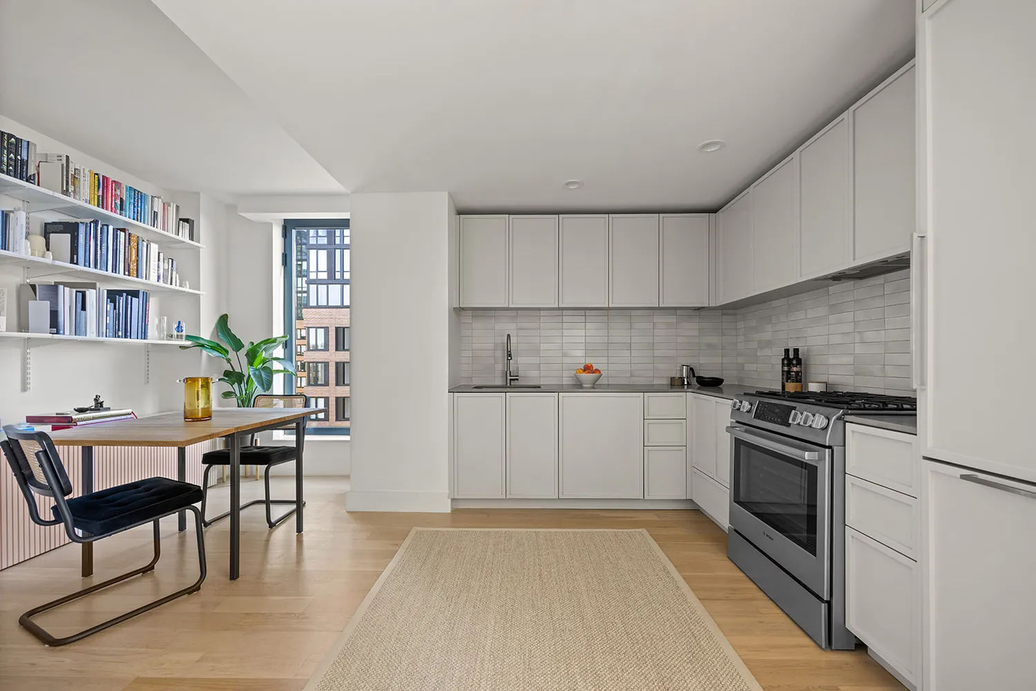 a kitchen with stainless steel appliances a stove a refrigerator sink cabinets and furniture