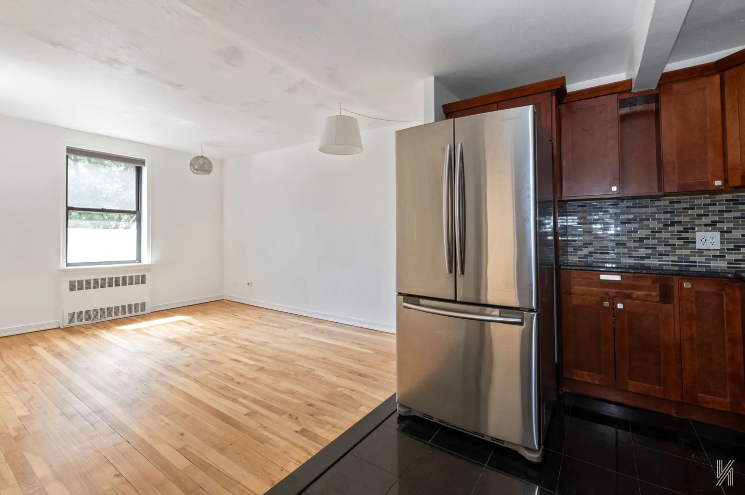 a kitchen with granite countertop a refrigerator and a sink