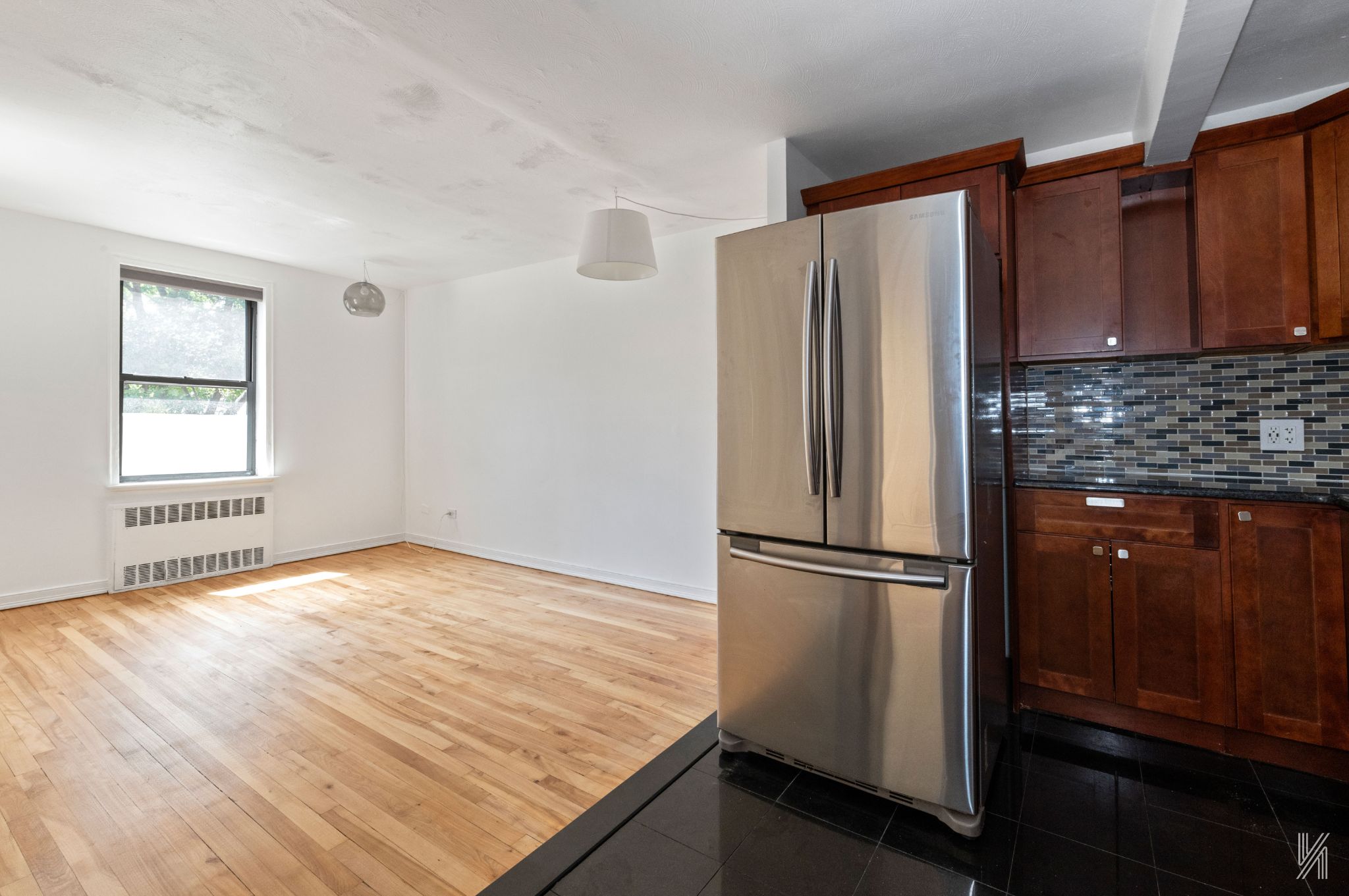 87-10 34th Avenue, Unit 1F Queens, NY 11372 - Photo 6 of 16 a kitchen with granite countertop a refrigerator and a sink