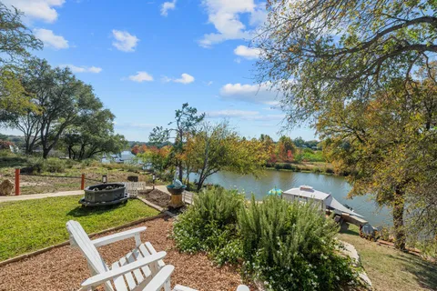 an aerial view of a house with a garden and lake view