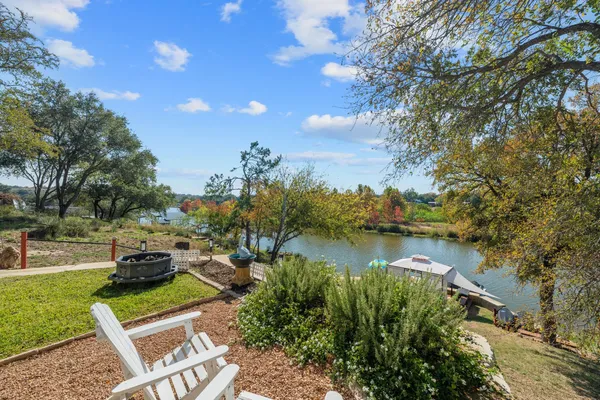 an aerial view of a house with a garden and lake view