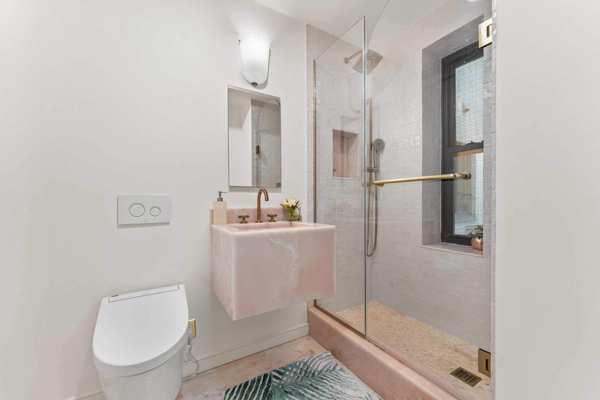 230 Central Park South, Unit 6DE Manhattan, NY 10019 - Photo 16 of 23 a bathroom with a shower a toilet and sink