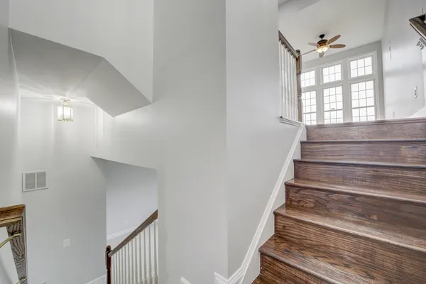 a view of entryway and hall with wooden floor