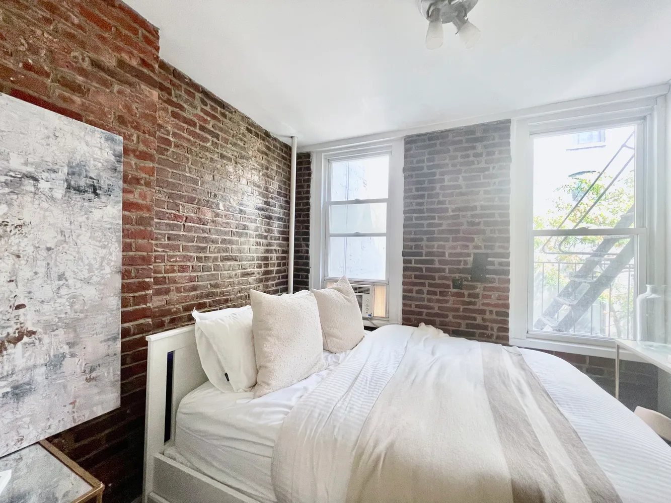 a bedroom with a bed and a large window