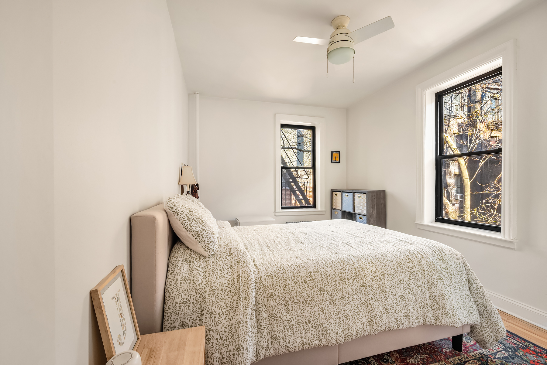 305 East 88th Street, Unit 3E Manhattan, NY 10128 - Photo 2 of 9 a bedroom with a bed and wooden floor