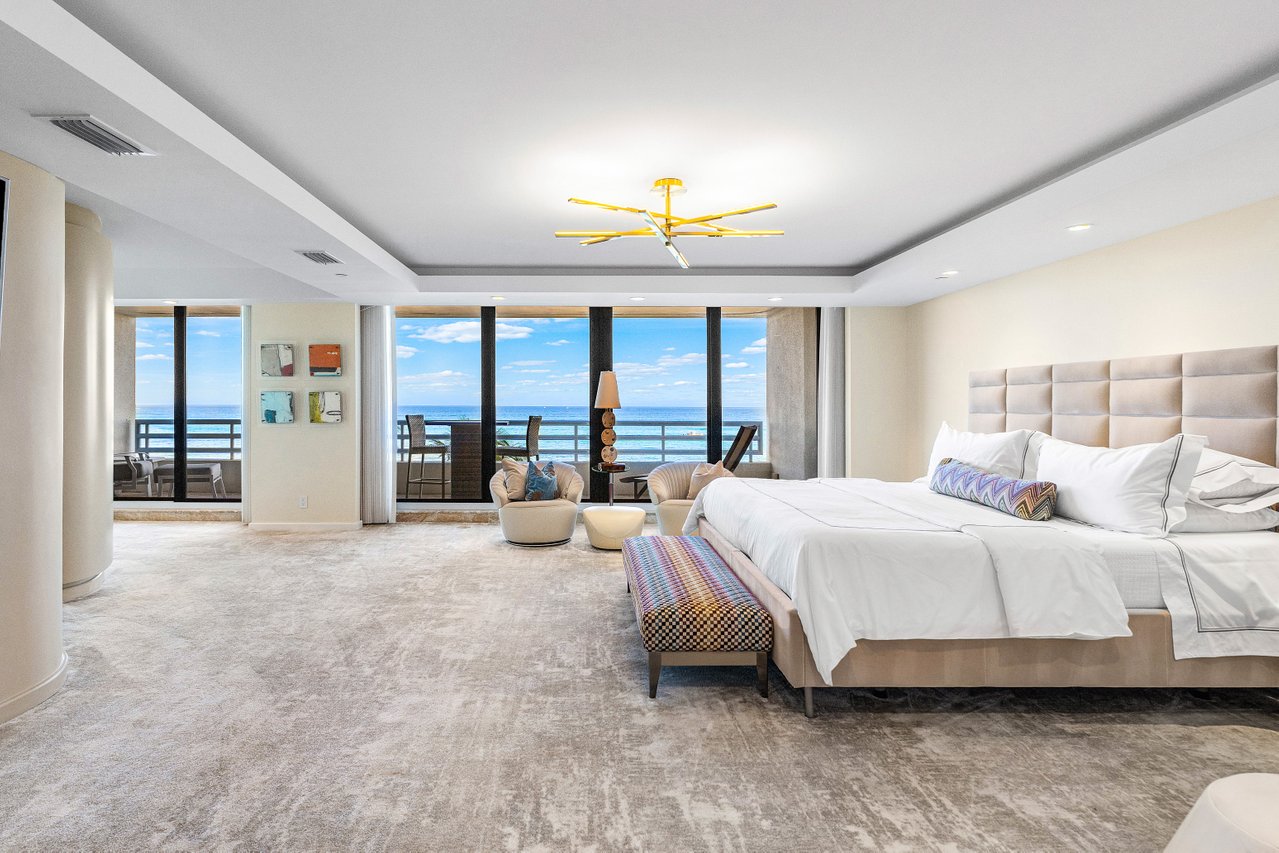 1500 South Ocean Boulevard, Unit 303/4 Boca Raton, FL 33432 - Photo 3 of 5 a spacious bedroom with a large bed and a chandelier