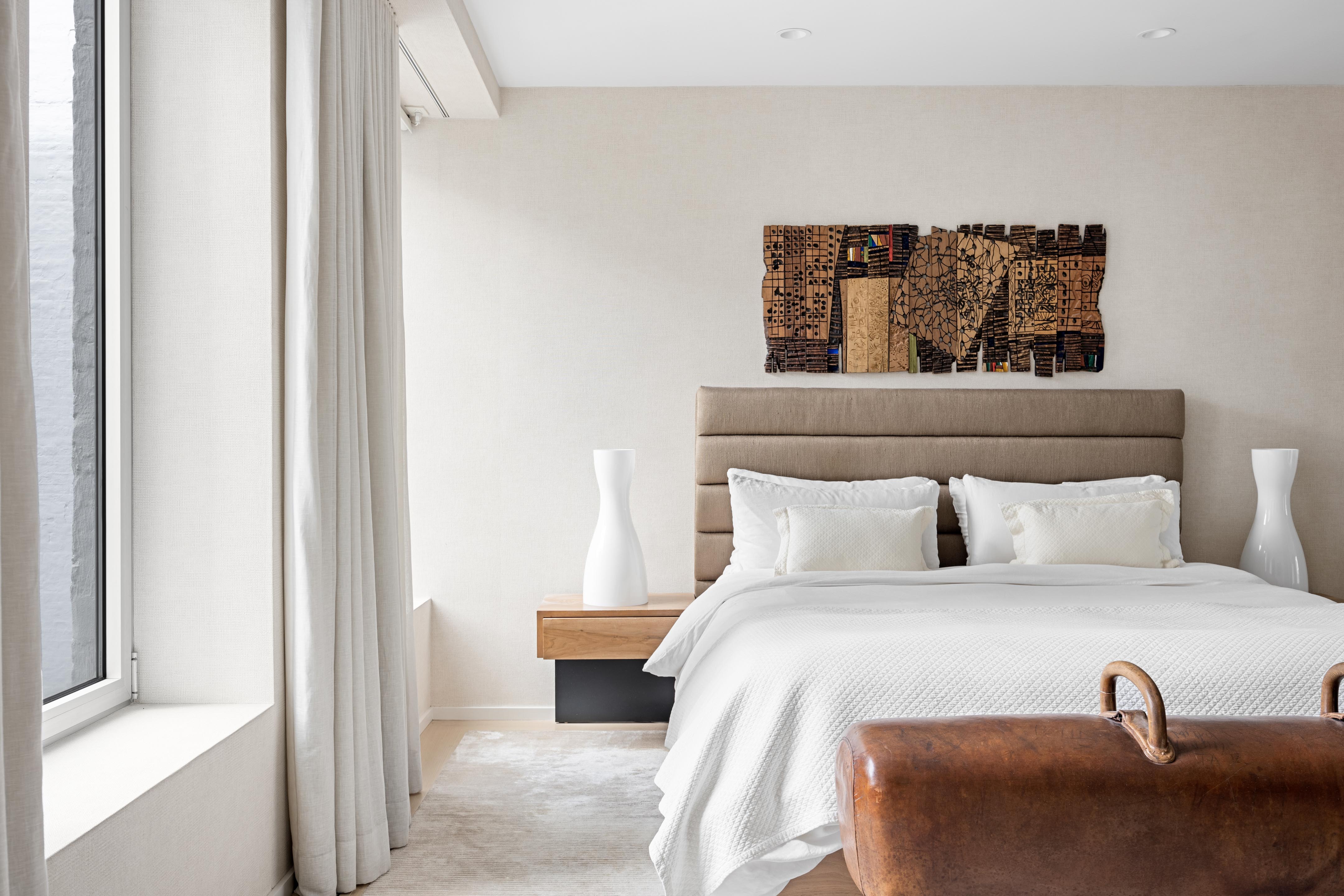 420 West Broadway, Unit 4W Manhattan, NY 10012 - Photo 9 of 17 a bedroom with a bed and a painting