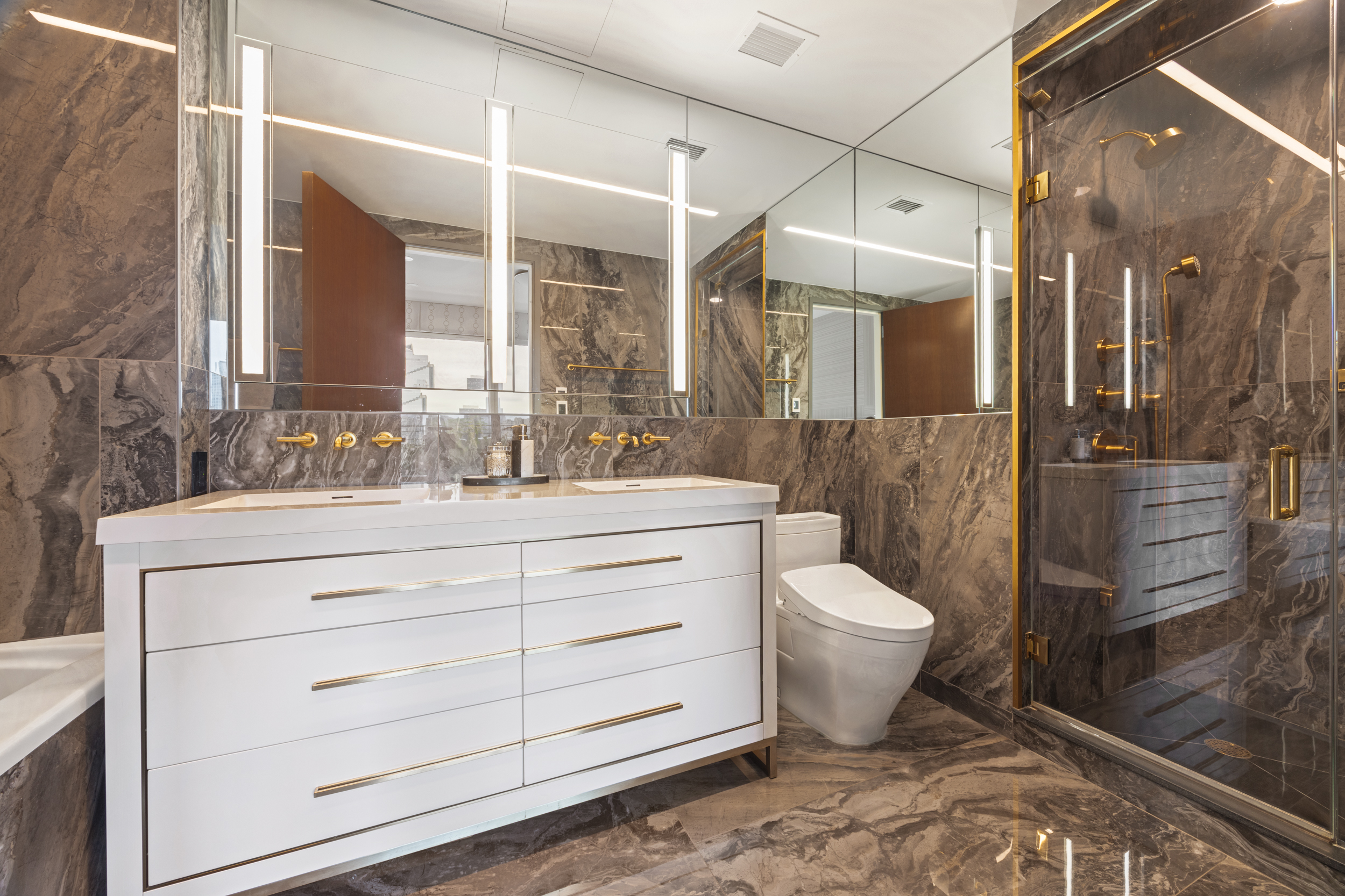 462 West 58th Street, Unit 9B Manhattan, NY 10019 - Photo 11 of 17 a bathroom with a sink toilet and shower