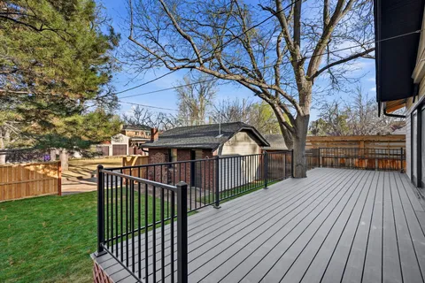 a view of a wooden deck and a yard
