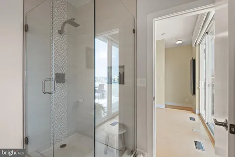 a view of a roof deck with table and chairs under an umbrella