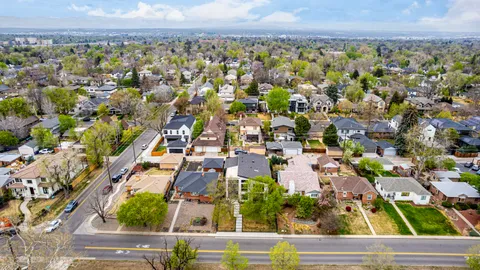 an aerial view of residential houses with outdoor space and street view