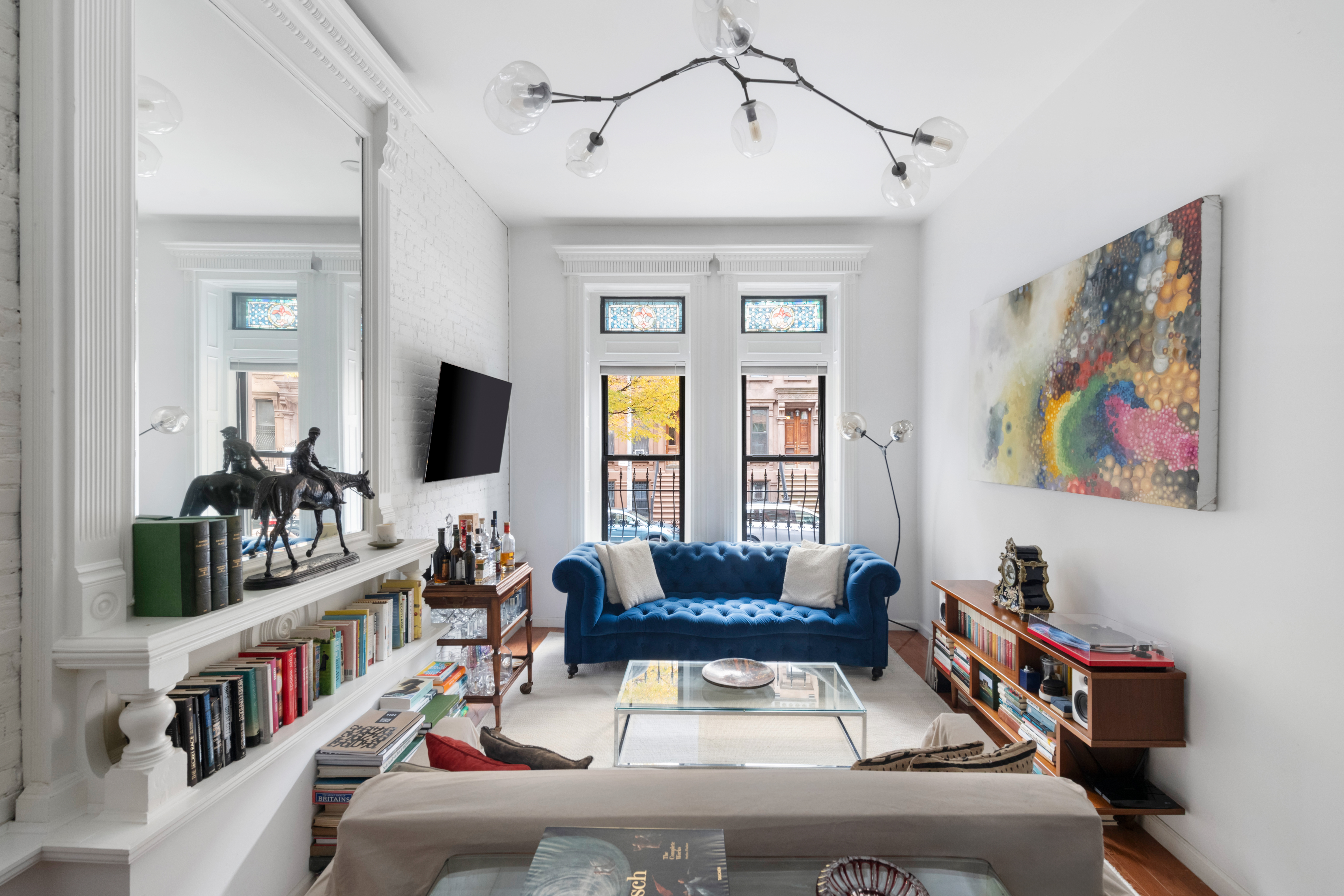 121 West 131st Street, Unit 2 Manhattan, NY 10027 - Photo 2 of 14 a living room with furniture and a flat screen tv