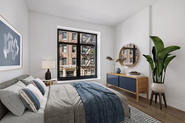 17 Convent Avenue, Unit 3D Manhattan, NY 10027 - Photo 6 of 9 a bedroom with a bed wooden floor and window