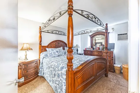 a bedroom with bed and a balcony