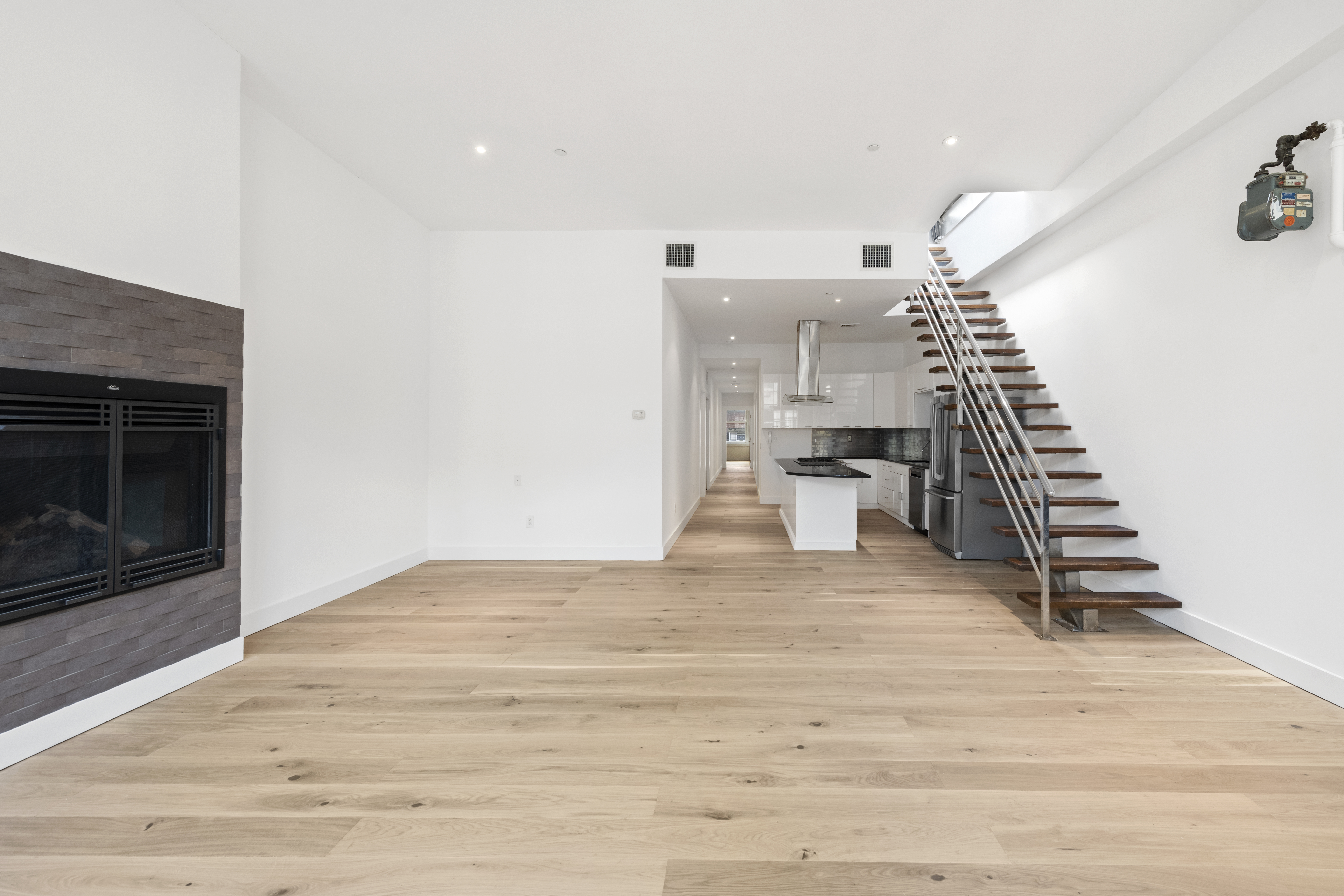 49 Walker Street, Unit PH Manhattan, NY 10013 - Photo 5 of 14 a view of empty room with wooden floor and fireplace